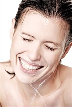 Young woman with water drops in face