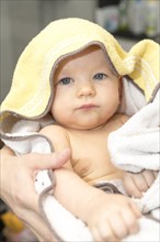 Infant wrapped in bath towel