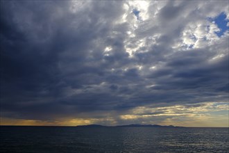 Thunderclouds at sunset on the beach