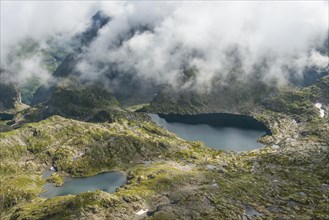 Clouds passing over a ridge with mountain lakes