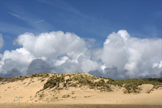 Dune with cumulus clouds