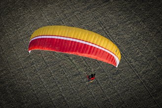 Paraglider over ploughed field