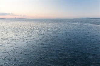 Ice on the shore of Lake Constance on a winter evening