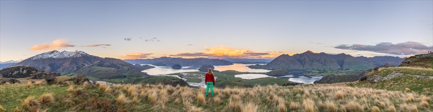 Hiker overlooking Lake Wanaka and mountains