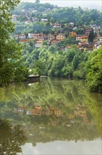 Village reflecting in the water near Sarajevo