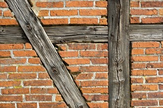 Brick wall with half-timbered beams