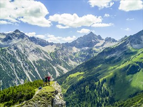 Three hikers in the mountains