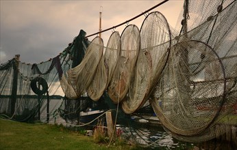 Fish traps and fishing nets hang to dry