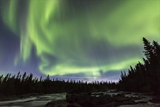 Northern Lights or Aurora Borealis above river Gamajahka or Kamajakka