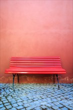 Red bench and red wall
