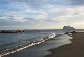 View of The Rock of Gibraltar and La Linea de la Concepcion as seen from the Mediterranean coast in the evening light