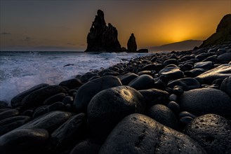 Rock formation Ribeira de Janela at sunrise with black stones at the beach
