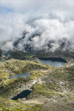 Clouds passing over a ridge with mountain lakes