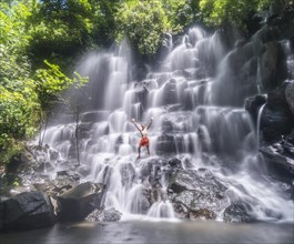 Man standing in a waterfall