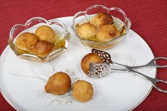 Swabian dessert on plate with pastry tongs