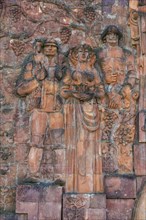 Close-up of figures from communist era on facade of city market