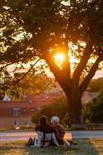 Visitors of the Medieval Week watch sunset over the Old Town