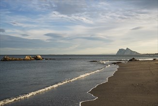 View of The Rock of Gibraltar and La Linea de la Concepcion as seen from the Mediterranean coast in the early morning light