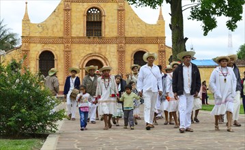 Locals dressed in festive costumes on the day of tradition in front of the Jesuit mission
