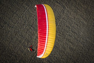 Paraglider over ploughed field