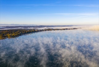Morning fog over Lake Starnberg with view on Seeshaupt near Munsing