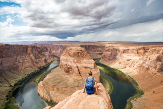 Young man sitting on a rock at Horseshoe Bend