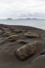 Rock on dune of lava sand