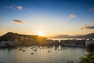 View of the village with harbour in the bay Baia del Silenzio at sunset