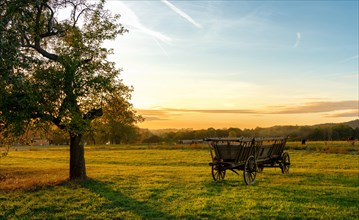 Hay wagon on the field at sunset