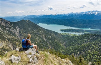 Hiker looking towards Lake Kochel from Heimgarten peak