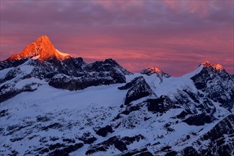 Zinalrothorn with snow in red dawn glow