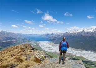 Hiker overlooking Lake Wakatipu from Mount Alfred