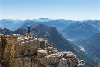 Hiker stretching arms in the air