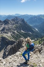 Hiker overlooks mountains and Alps