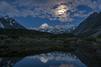 Mount Cook is reflected at moonlight in the pond
