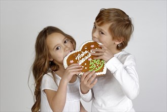 Children eating a gingerbread heart