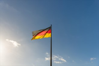 German flag in front of blue sky