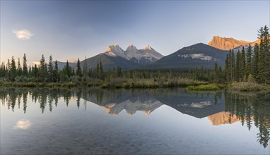 Three Sisters reflecting in calm water