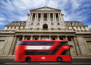 Bank of England with a passing red London double-decker bus