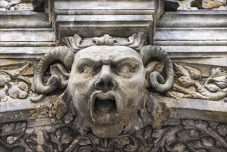 Grotesque at the archway of the grand gate