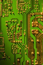 Green and gold computer circuit board close-up