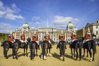 The Royal Guards in red uniform on horses