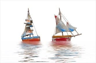 Two crafted sailboats