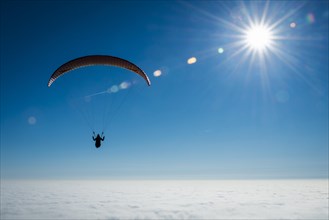Paraglider over closed cloud cover