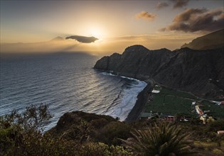 Sunrise at beach near Hermigua with view to Tenerife