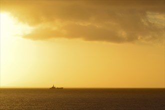 Ship on the horizon at sunset