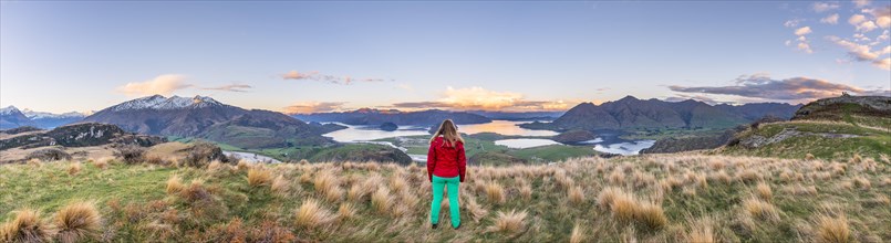 Hiker overlooking Lake Wanaka and mountains