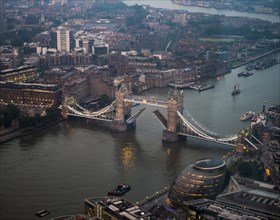 View of opened and illuminated Tower Bridge across the River Thames