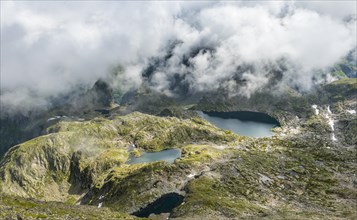 Clouds passing over a ridge with mountain lakes