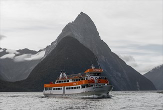 Tourist boat moving through Milford Sound
